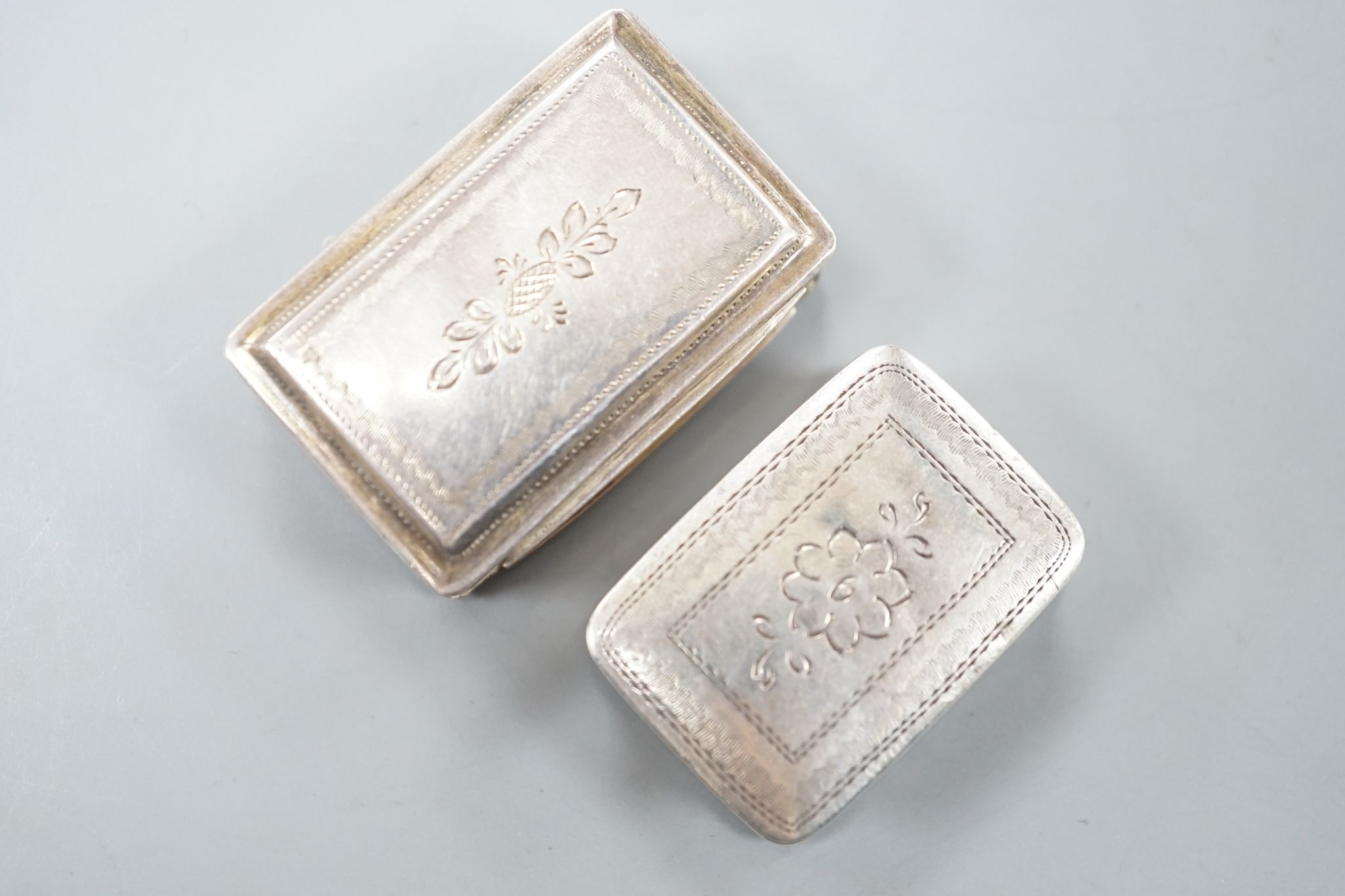 A George IV engraved silver rectangular vinaigrette, by Nathaniel Mills, Birmingham, 1827, engraved 'Celia', 31mm and a later vinaigrette, Birmingham, 1833.